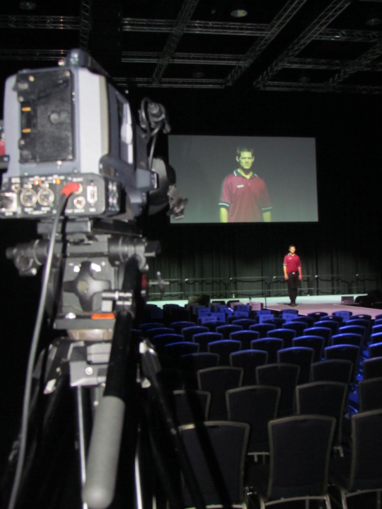 Professional video camera is capturing the speech on the stage